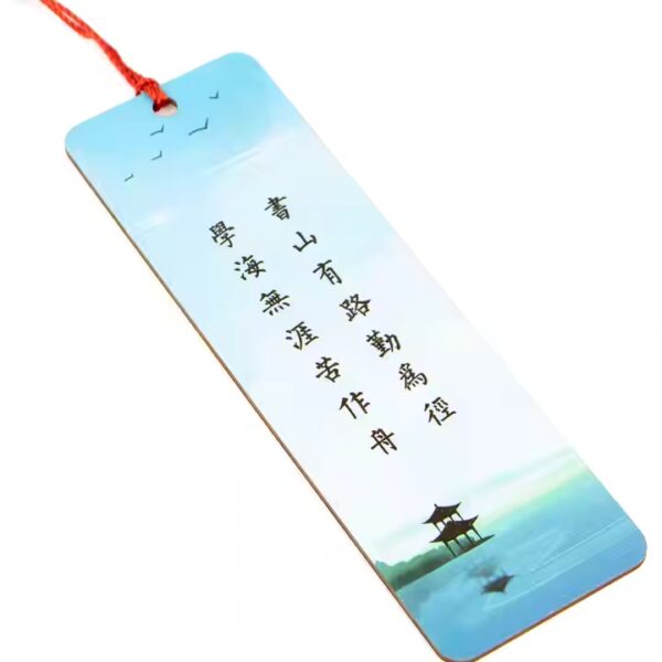 Custom wood bookmark with a red tassel, featuring a tranquil Asian-inspired design and Chinese calligraphy.