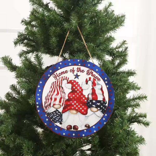 Patriotic gnomes on a round wooden door hanger; "Home of the Brave". Wholesale door hanging wood decoration.