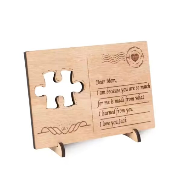 Engraved wooden postcard with puzzle piece cutout, reading "Dear Mom, I am because you are...