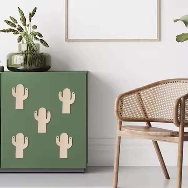 Wooden cactus wall hooks on green cabinet; creative home decor.